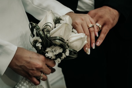 A close up of a person holding a bouquet of flowers
