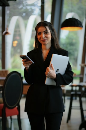 A woman standing in a restaurant holding a tablet