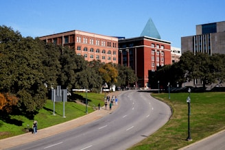A wide street with a building in the background
