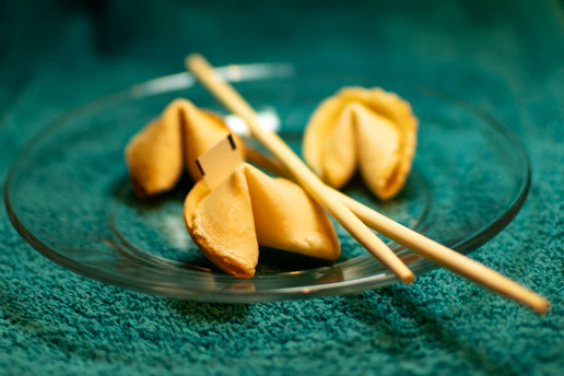 A plate of dumplings with chopsticks on a green cloth