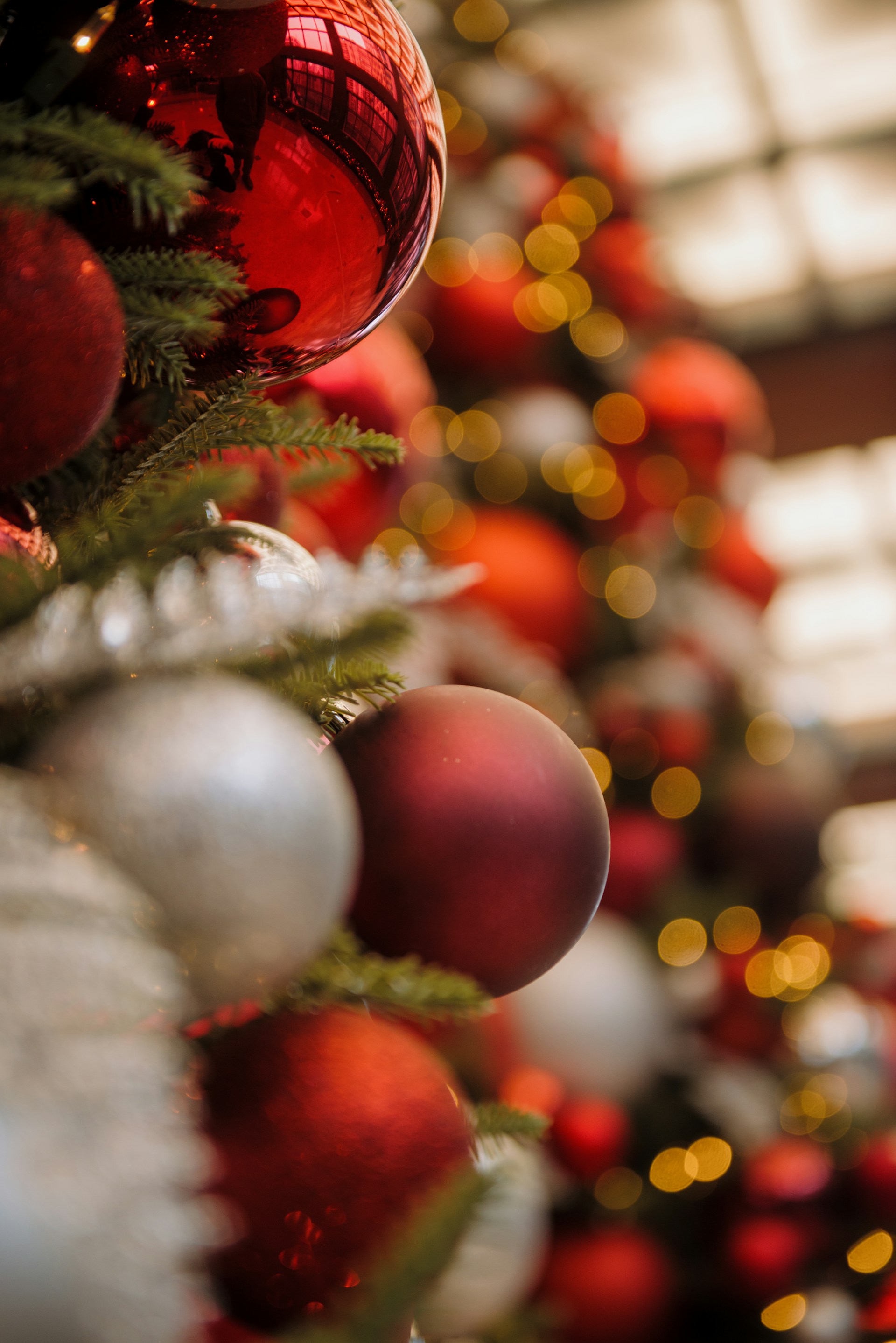 A christmas tree with red and silver ornaments