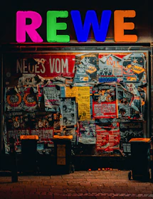 A store front with a neon sign above it