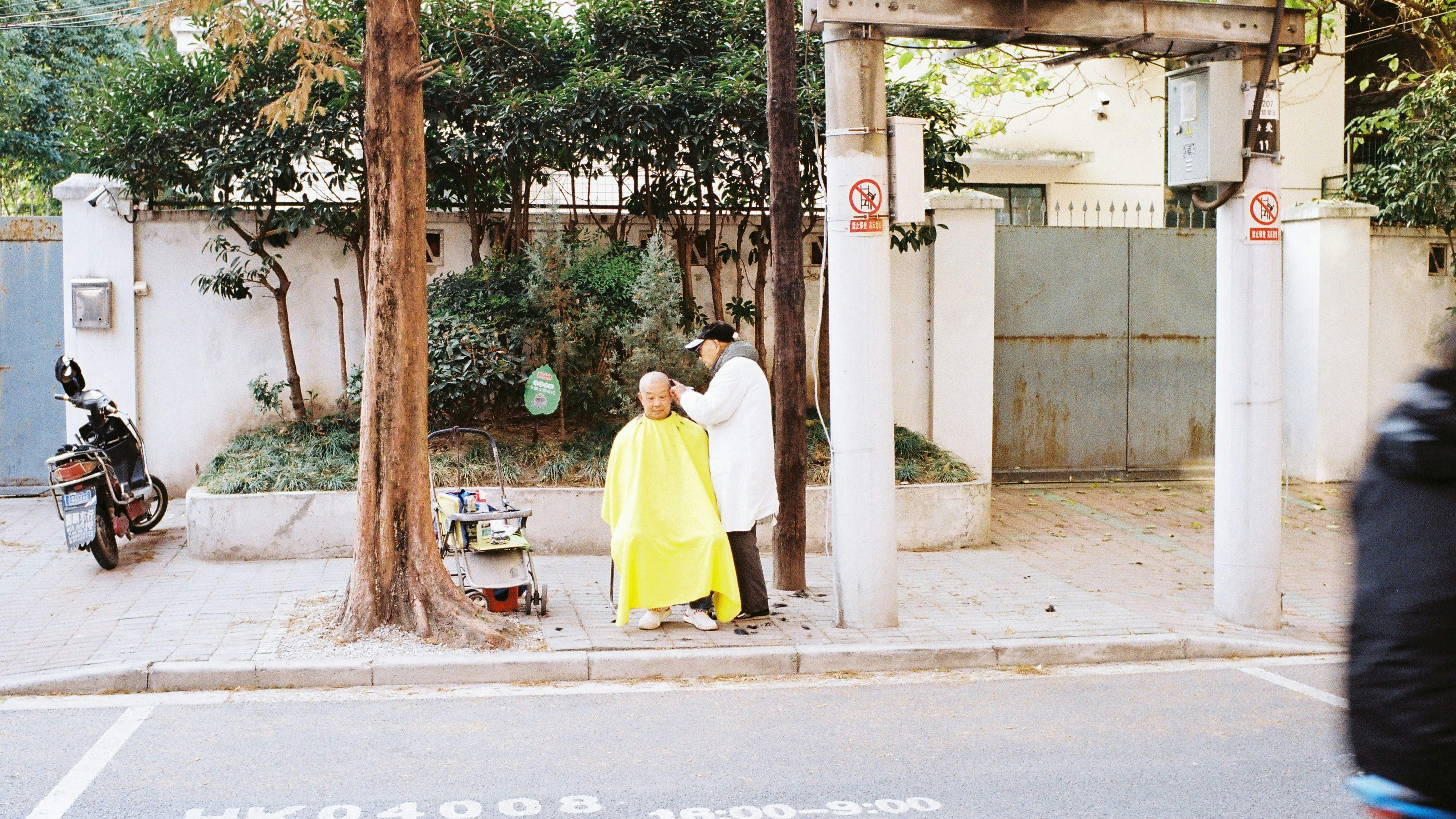 A man and a woman standing on a street corner