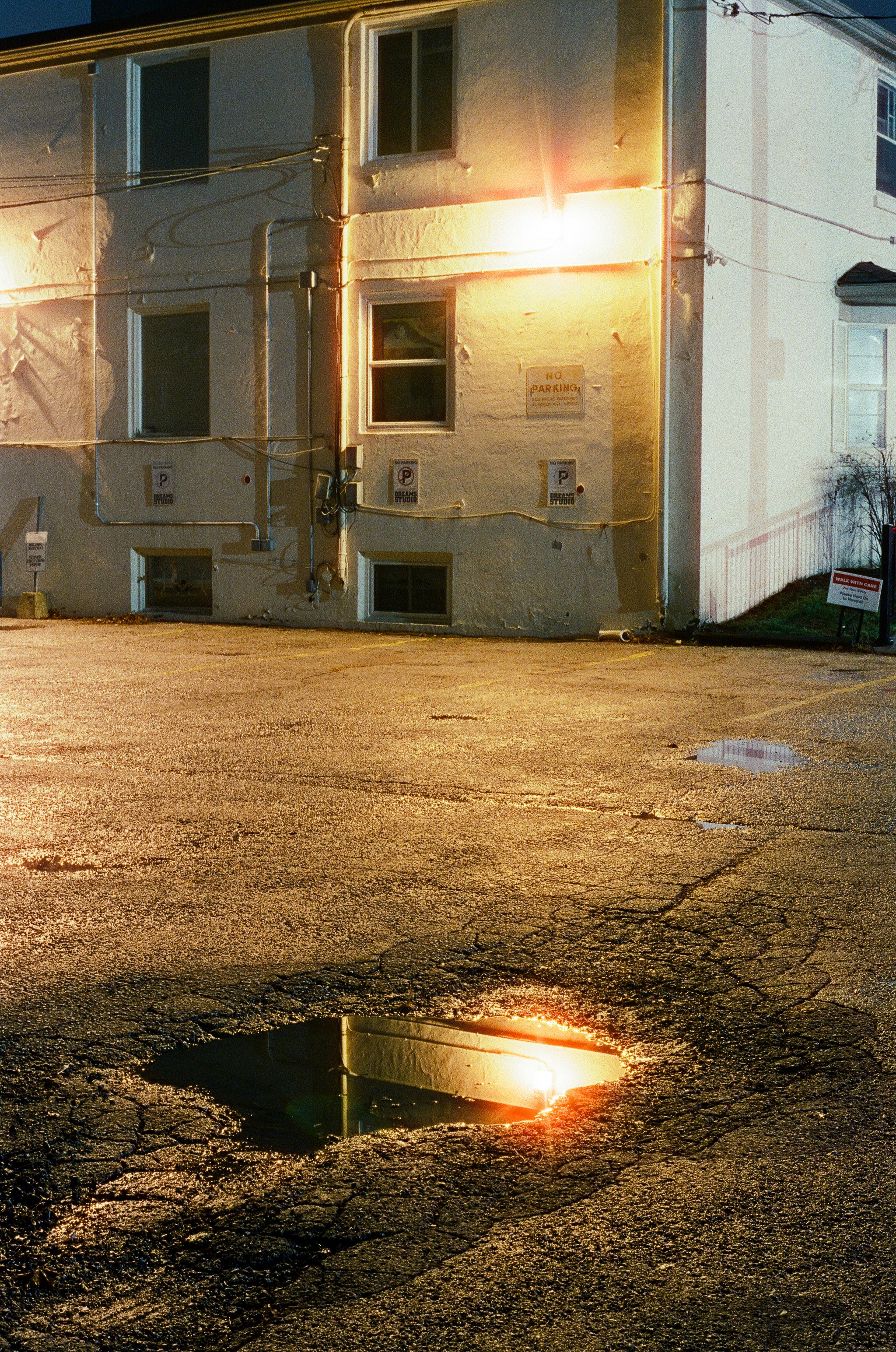 A fire hydrant sitting in the middle of a parking lot