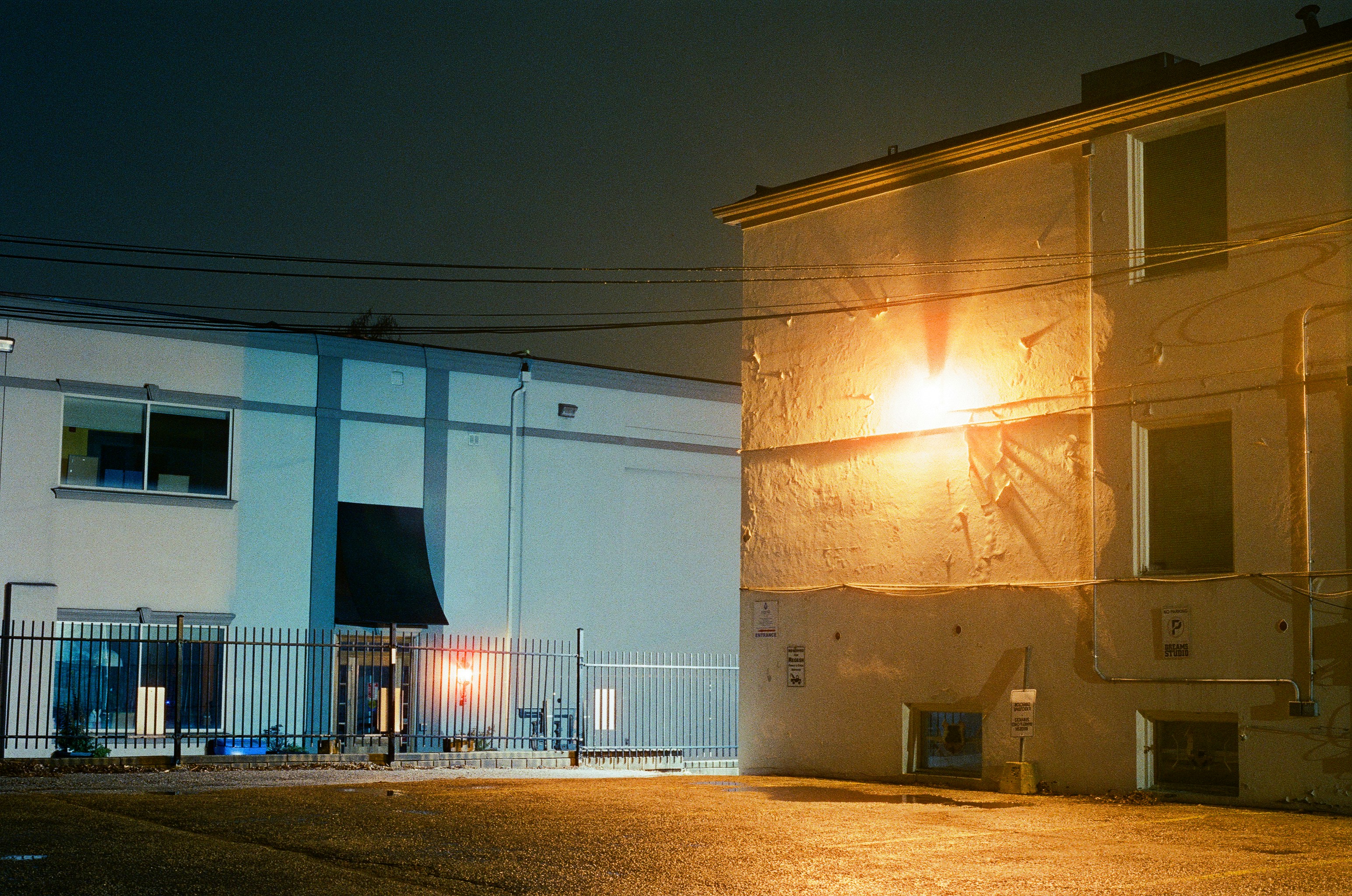 An empty parking lot with a building in the background