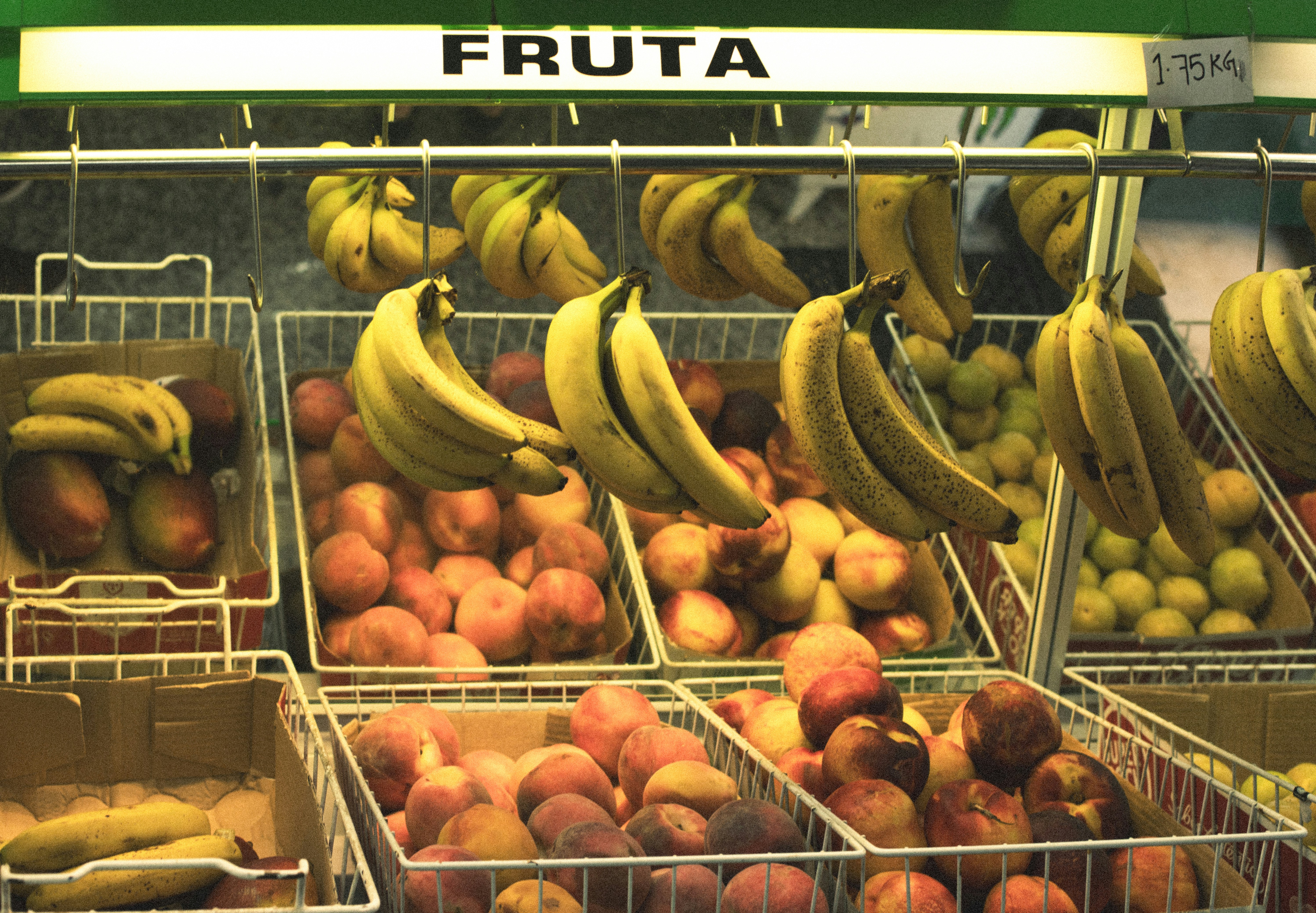 A fruit stand with a variety of fruits in baskets