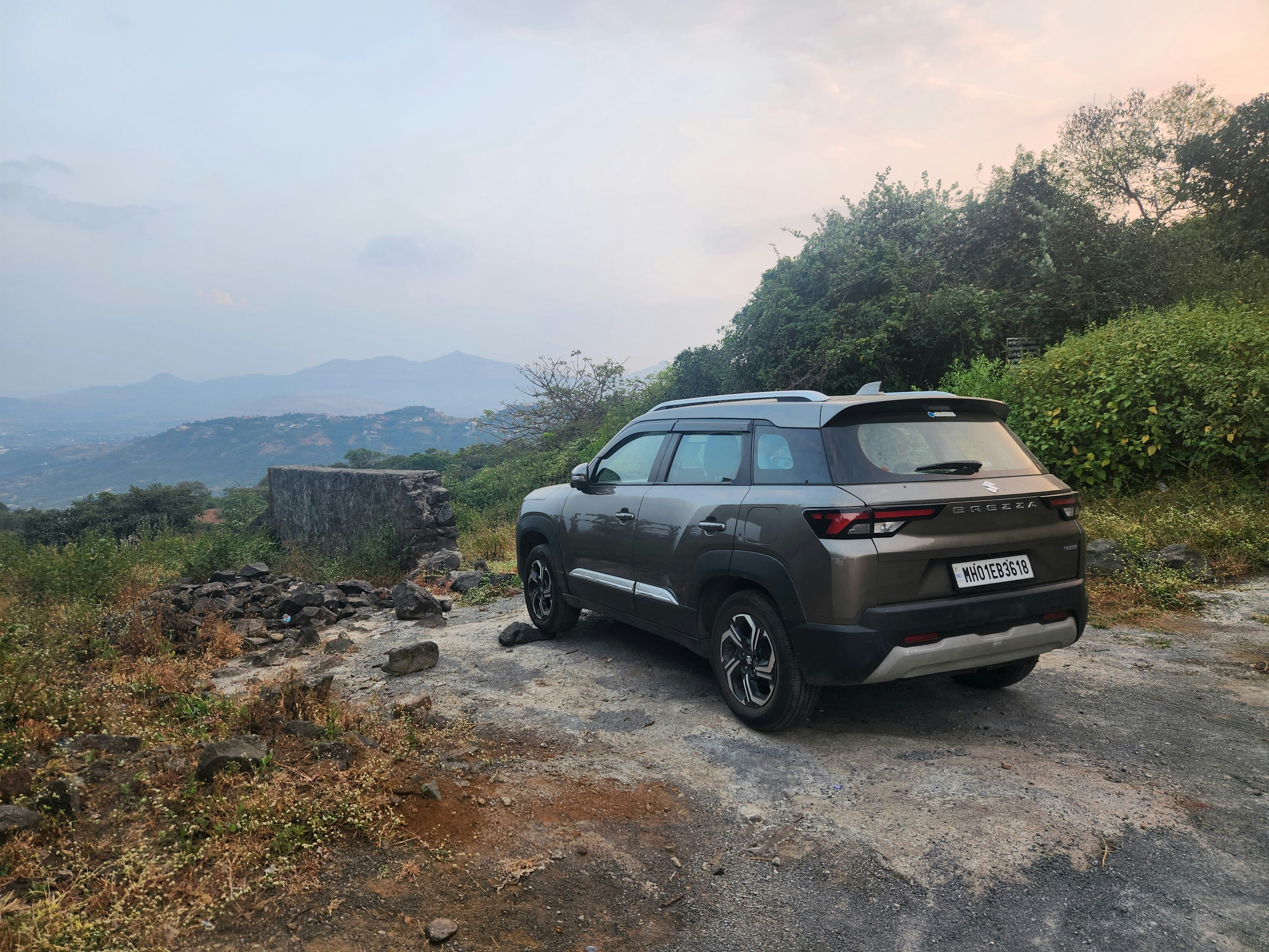 A car parked on the side of a dirt road