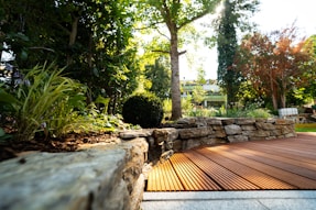 A wooden deck surrounded by rocks and trees