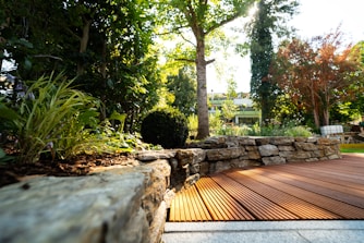 A wooden deck surrounded by rocks and trees