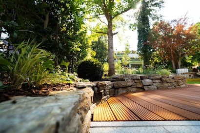A wooden deck surrounded by rocks and trees