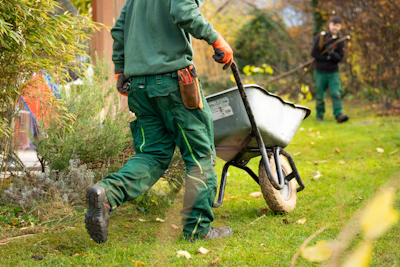 A man pulling a wheelbarrow with a wheel