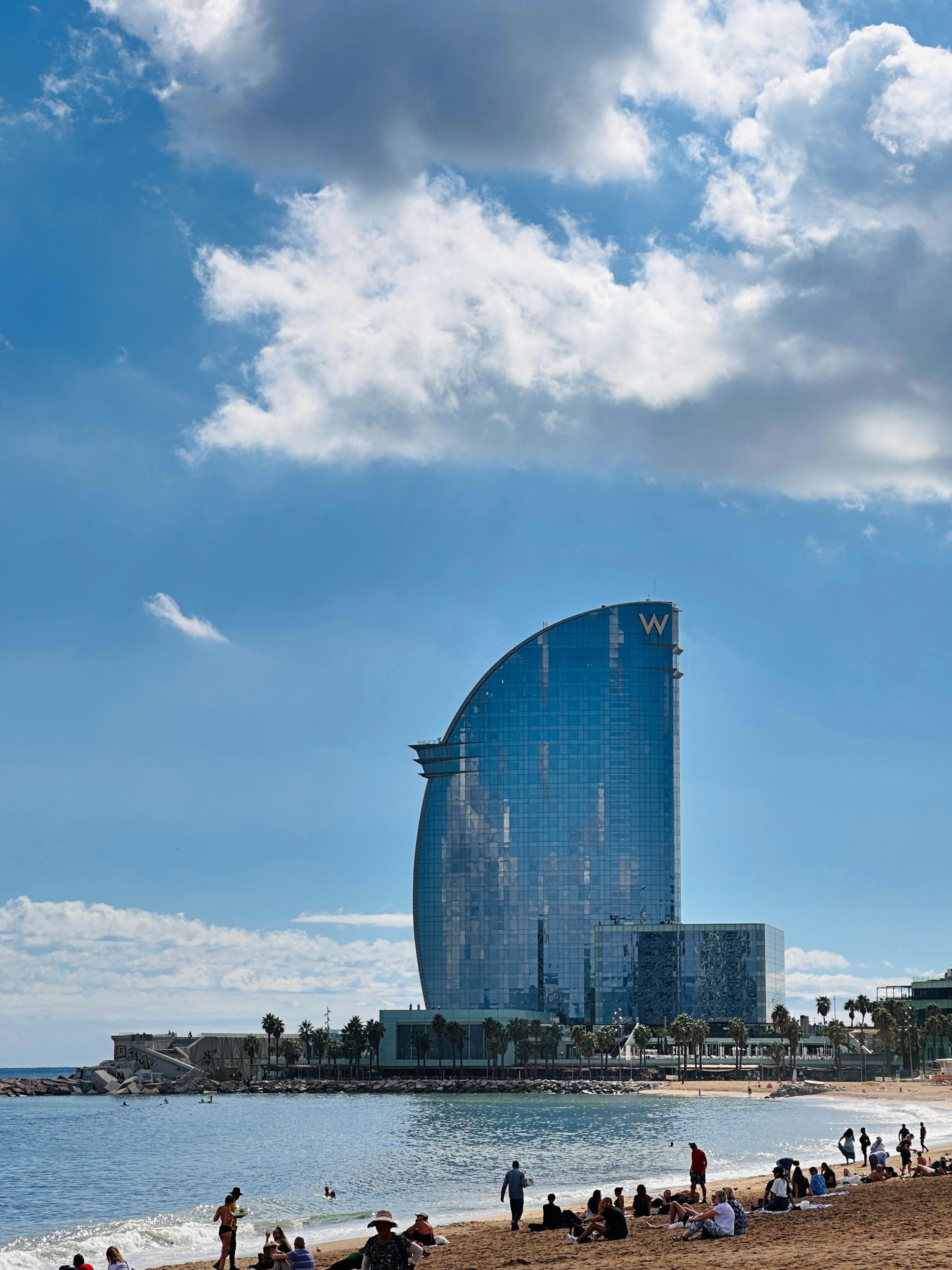 A group of people standing on top of a sandy beach