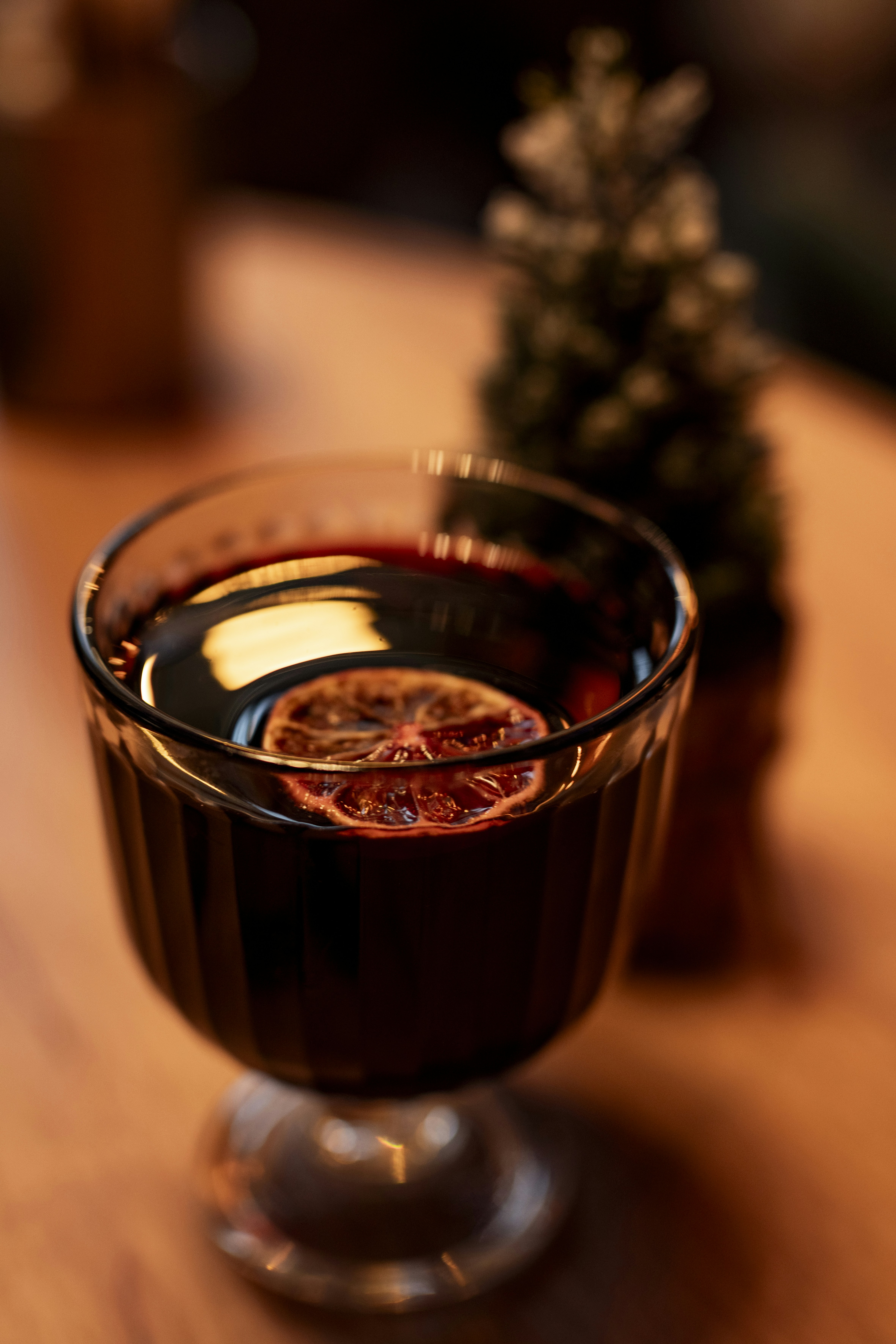 A glass filled with liquid sitting on top of a wooden table