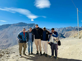 A group of men standing on top of a mountain
