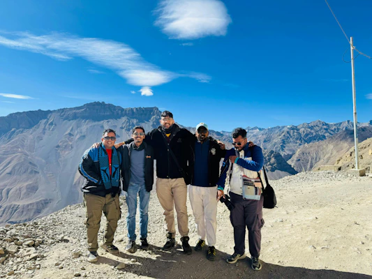 A group of men standing on top of a mountain