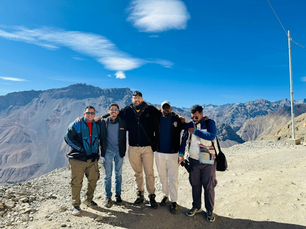 A group of men standing on top of a mountain