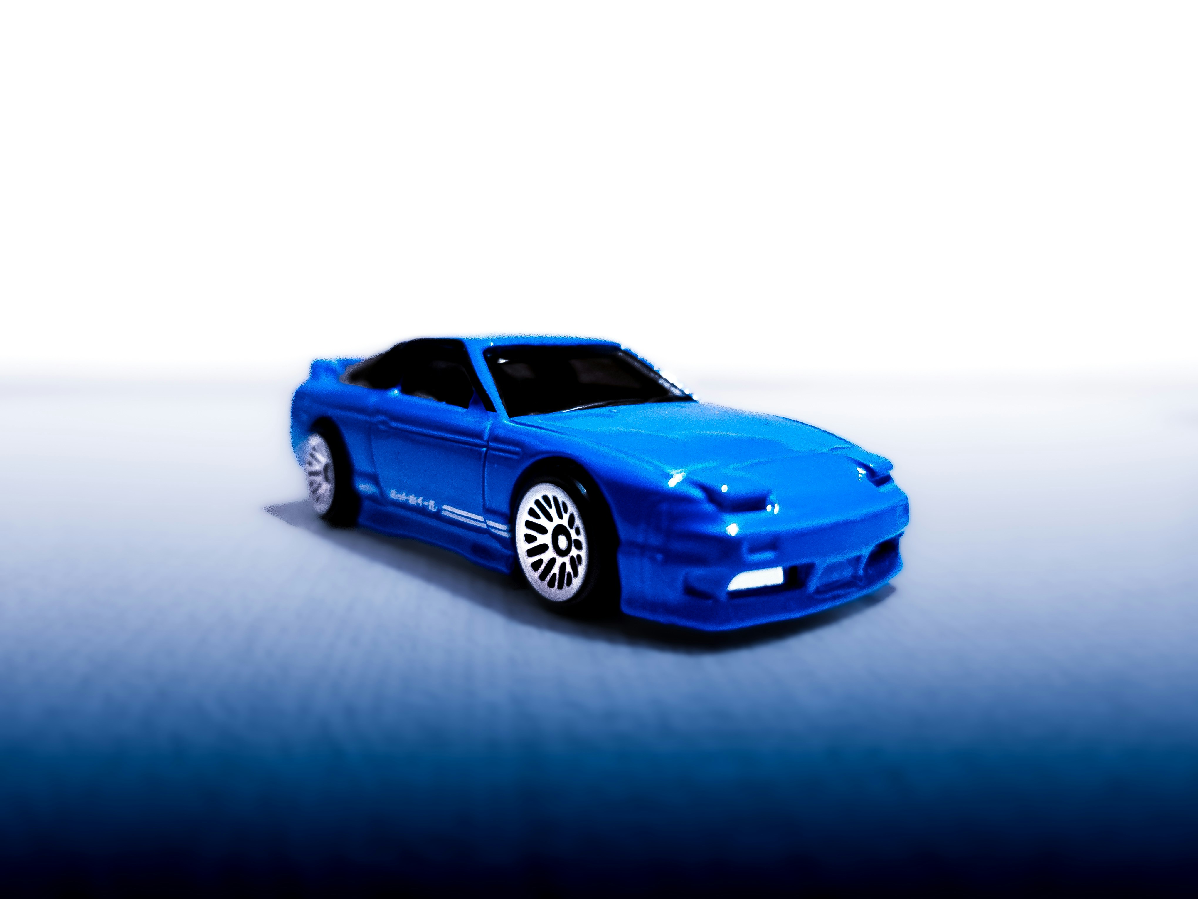 A blue sports car on a white background