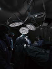 A group of doctors standing around a hospital bed