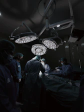 A group of doctors standing around a hospital bed