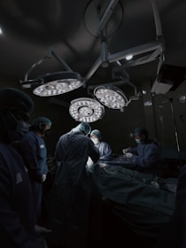 A group of doctors standing around a hospital bed