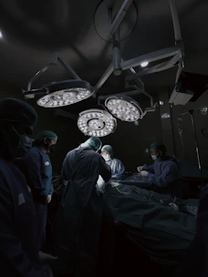 A group of doctors standing around a hospital bed
