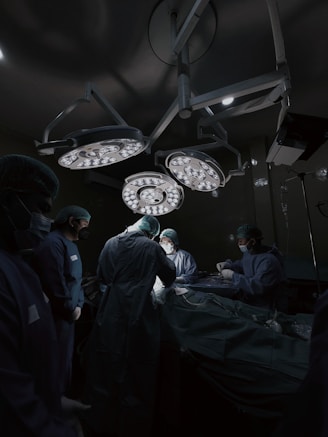 A group of doctors standing around a hospital bed