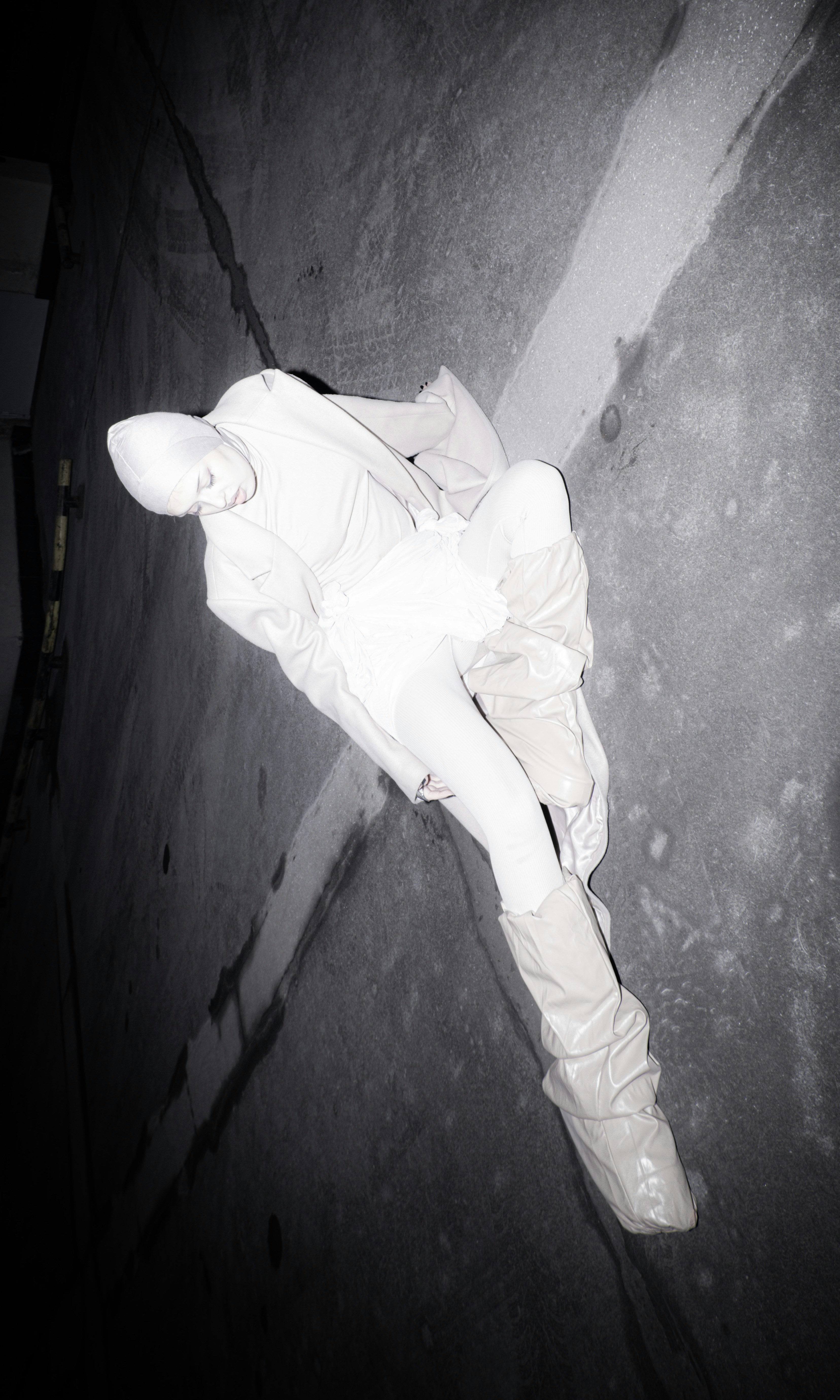 A person laying on the ground in the dark