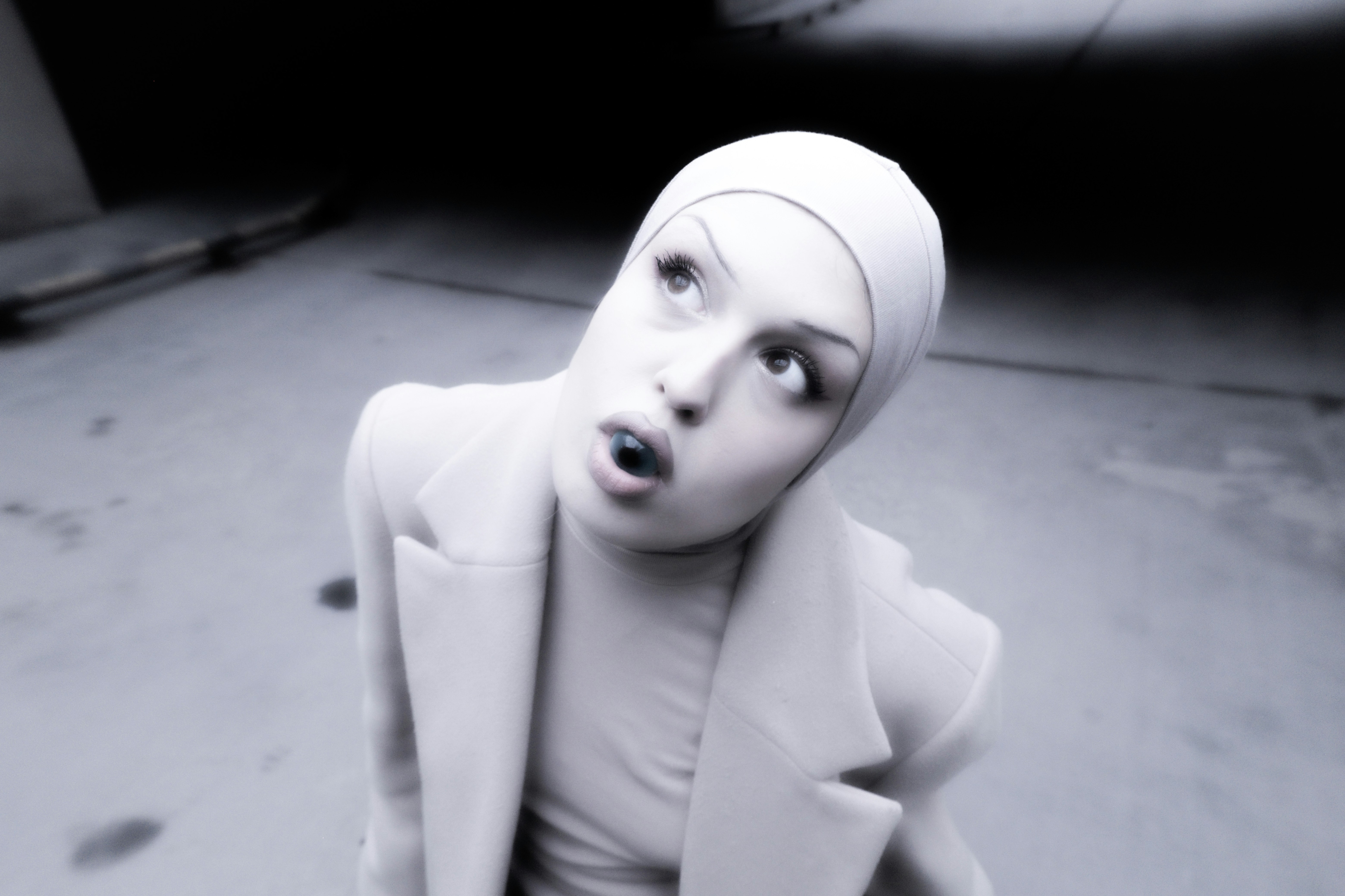 A woman in a white suit and head scarf