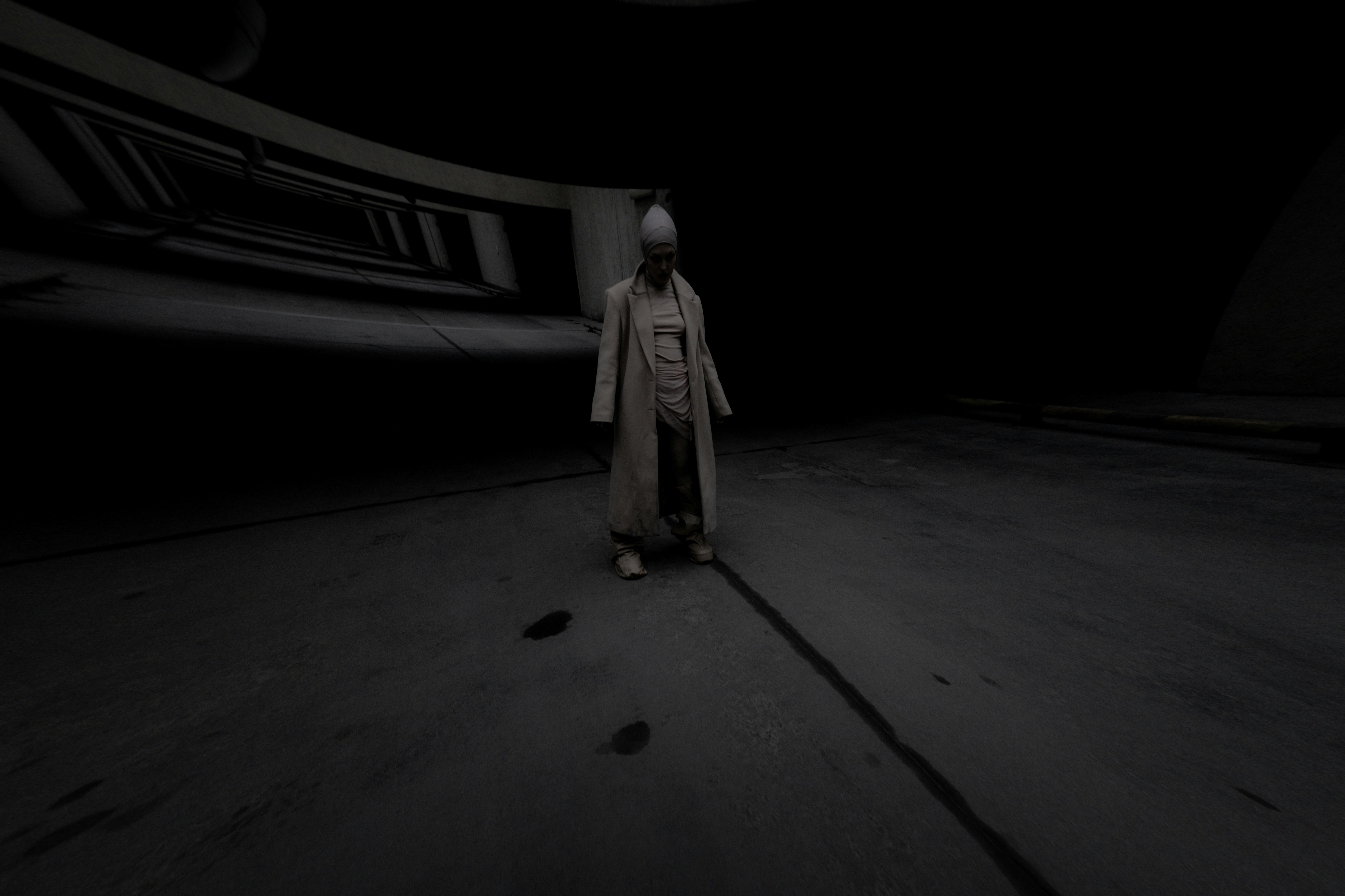 A person standing alone in a dark room