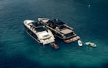 A couple of boats floating on top of a body of water