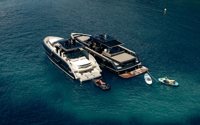 A couple of boats floating on top of a body of water