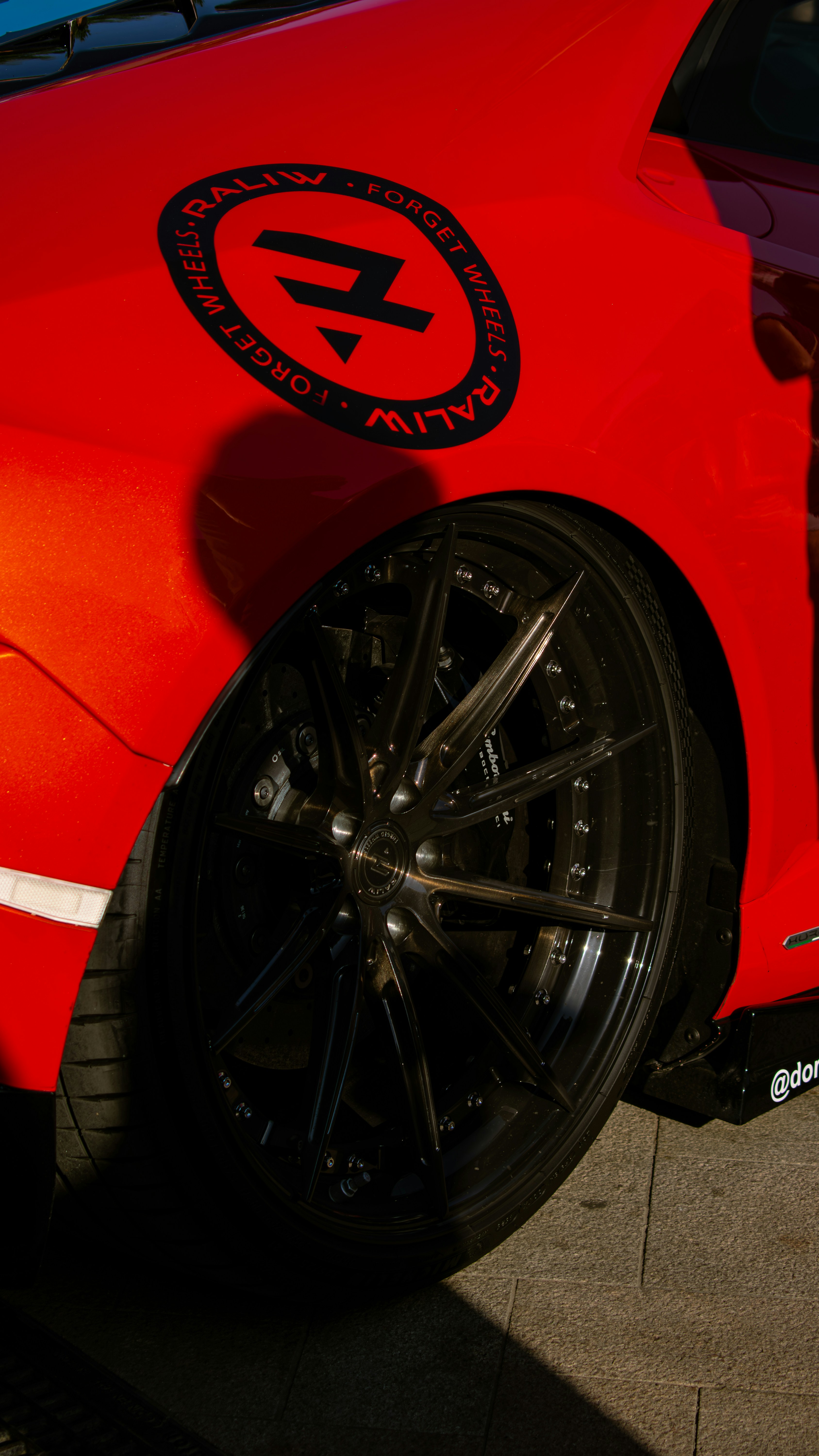 A close up of a red sports car with a sticker on it photo – Free Iași ...