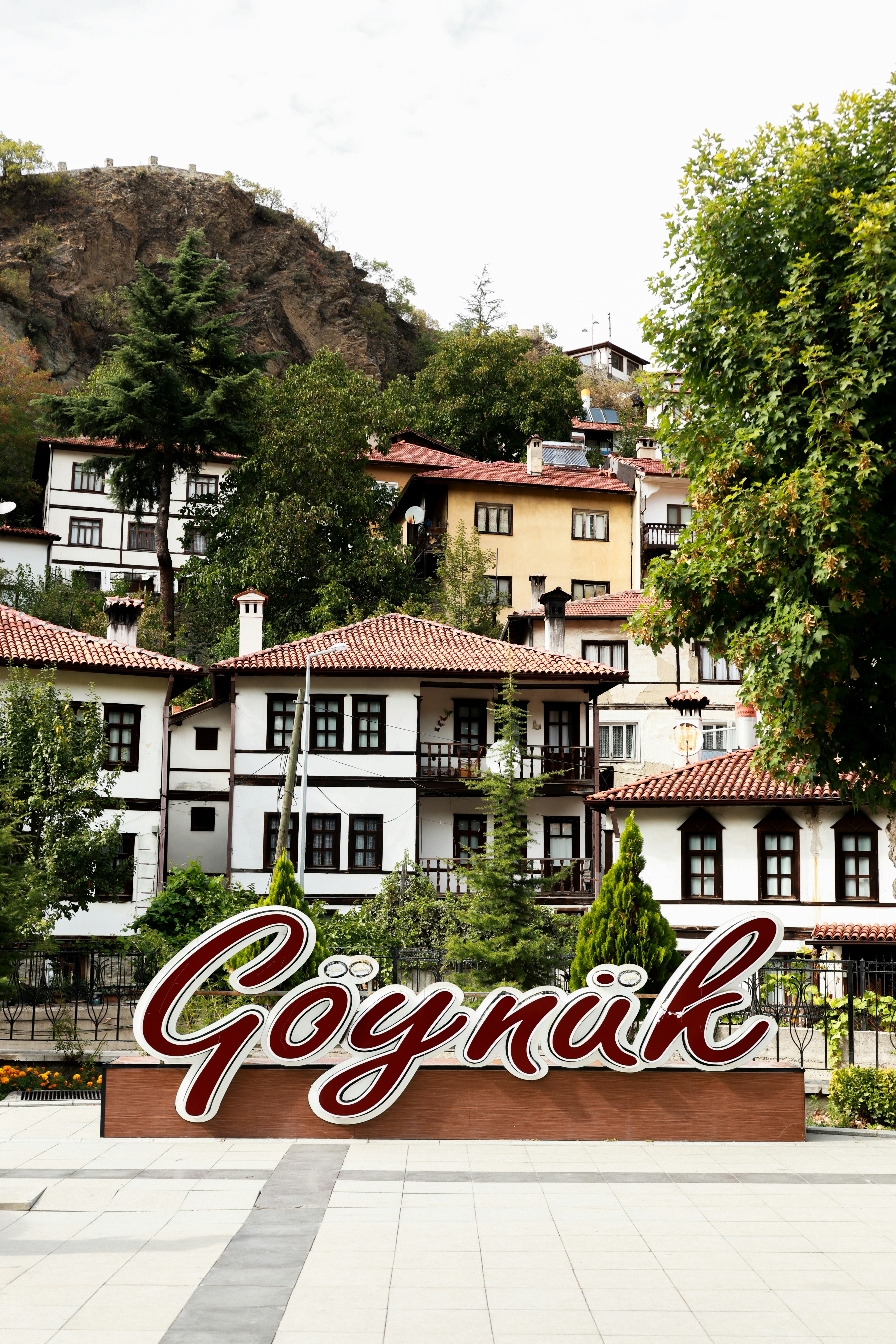 A large sign that says gornik in front of some buildings
