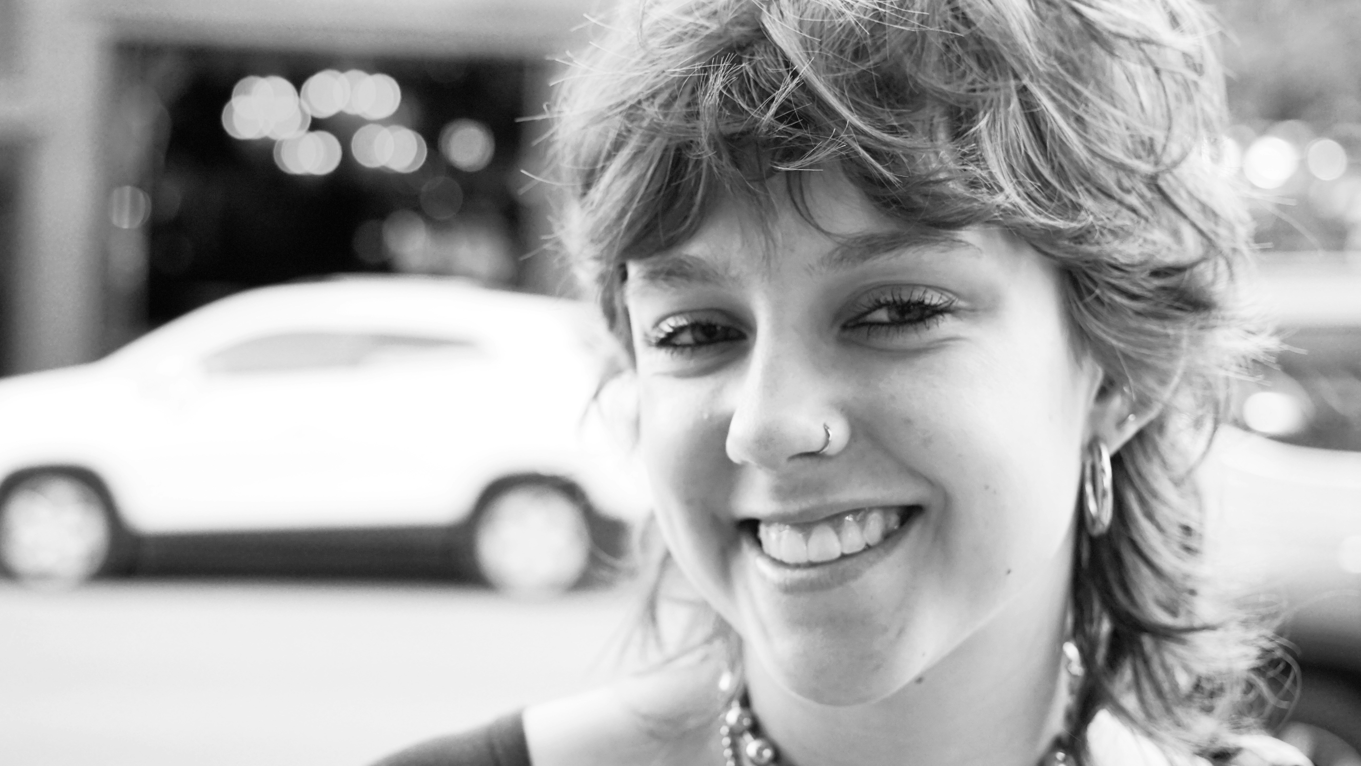 A black and white photo of a woman smiling