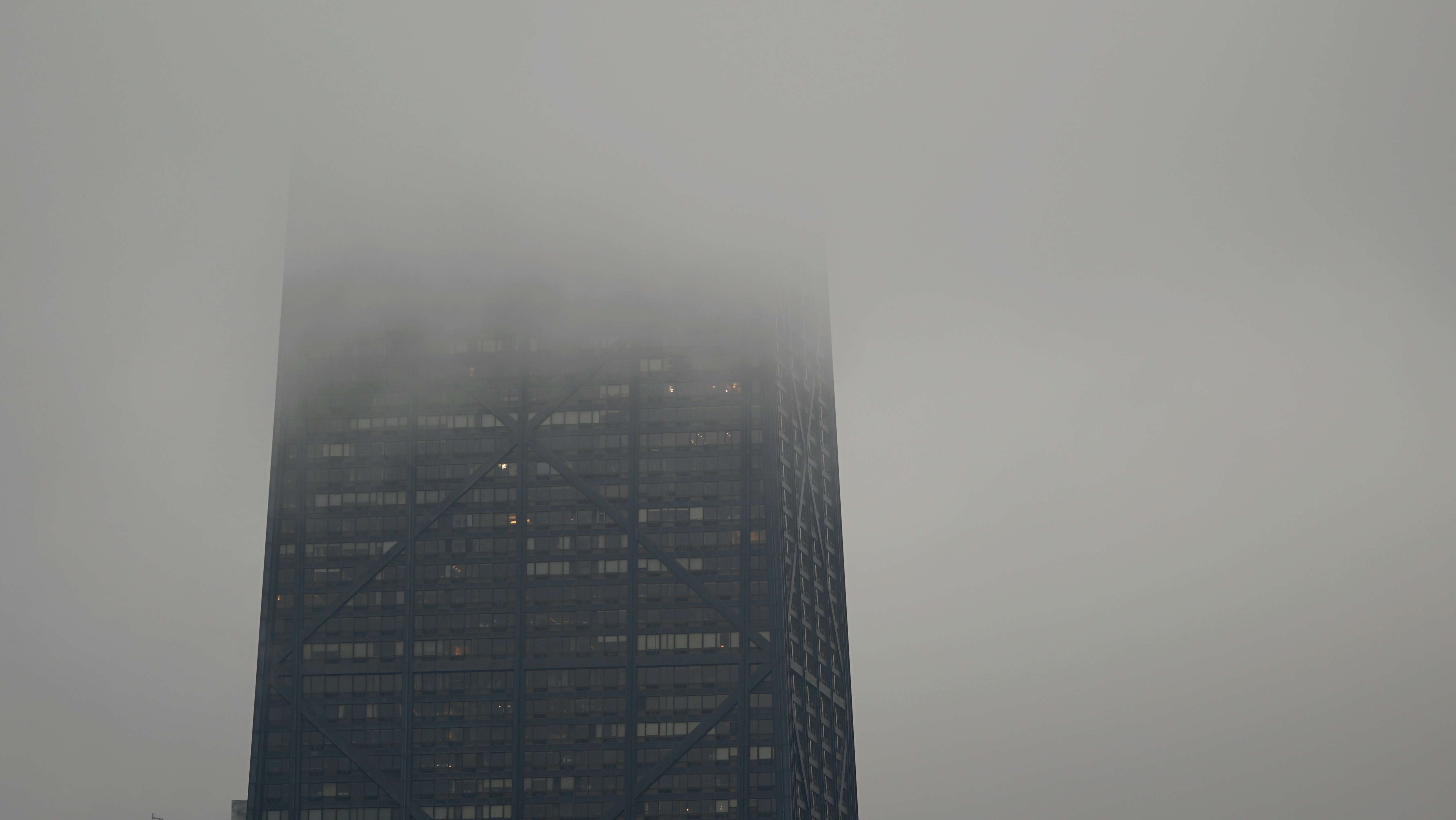 A very tall building with a very foggy sky in the background