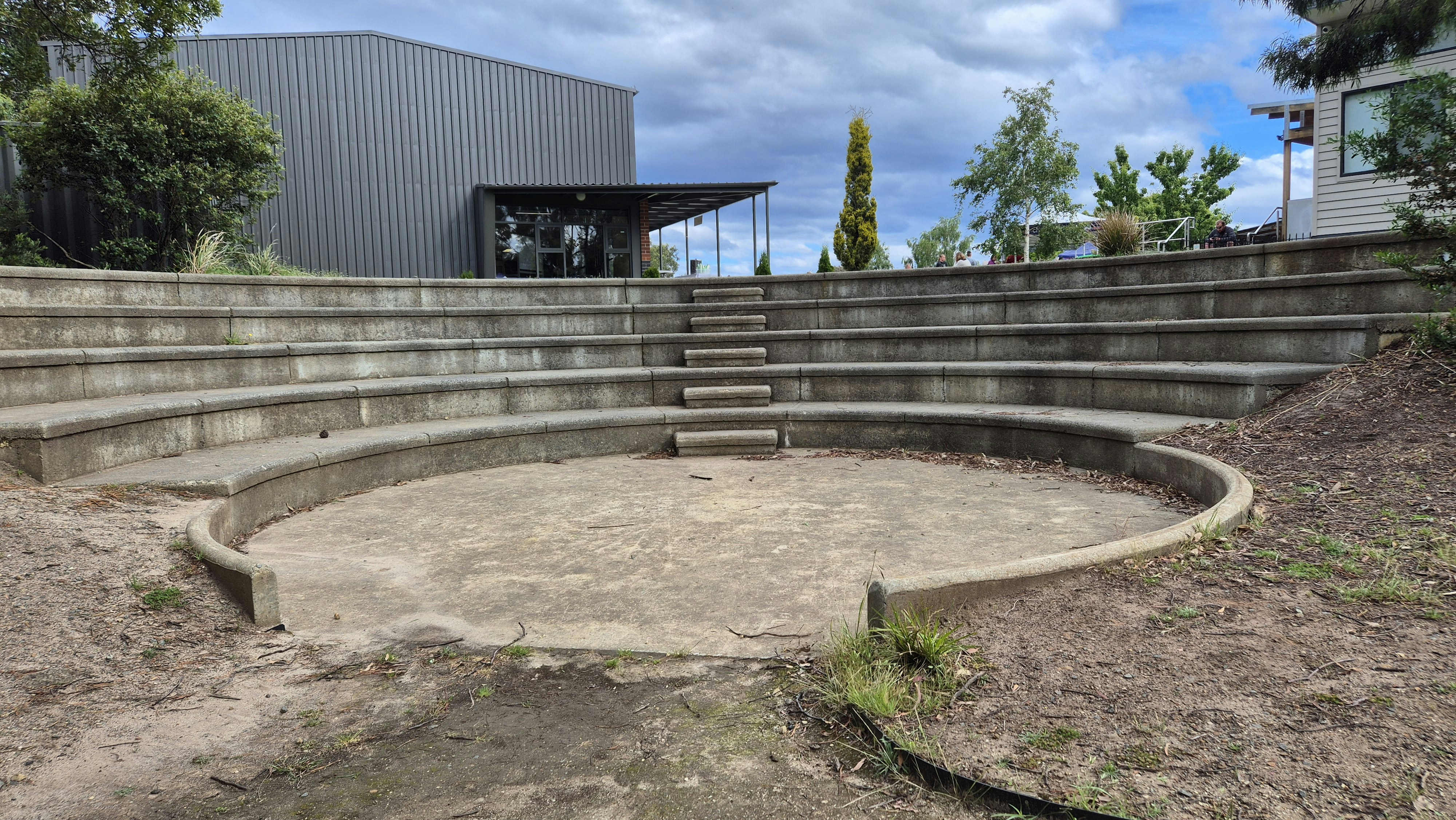 An outdoor seating area with steps leading up to a building