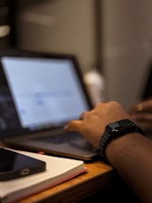 A person using a laptop computer on a desk