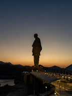 A statue of a man standing on top of a building