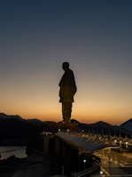 A statue of a man standing on top of a building