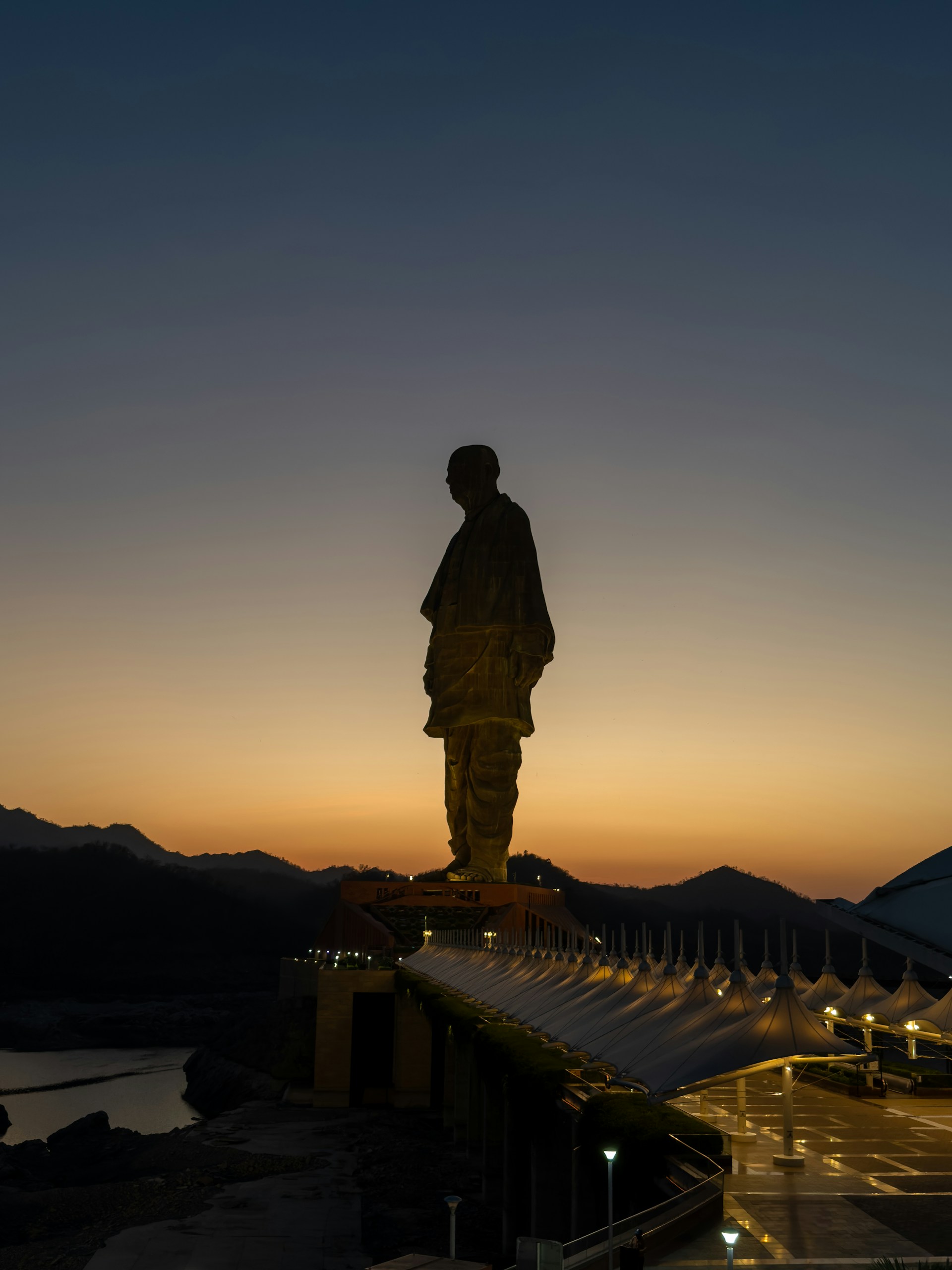 A statue of a man standing on top of a building