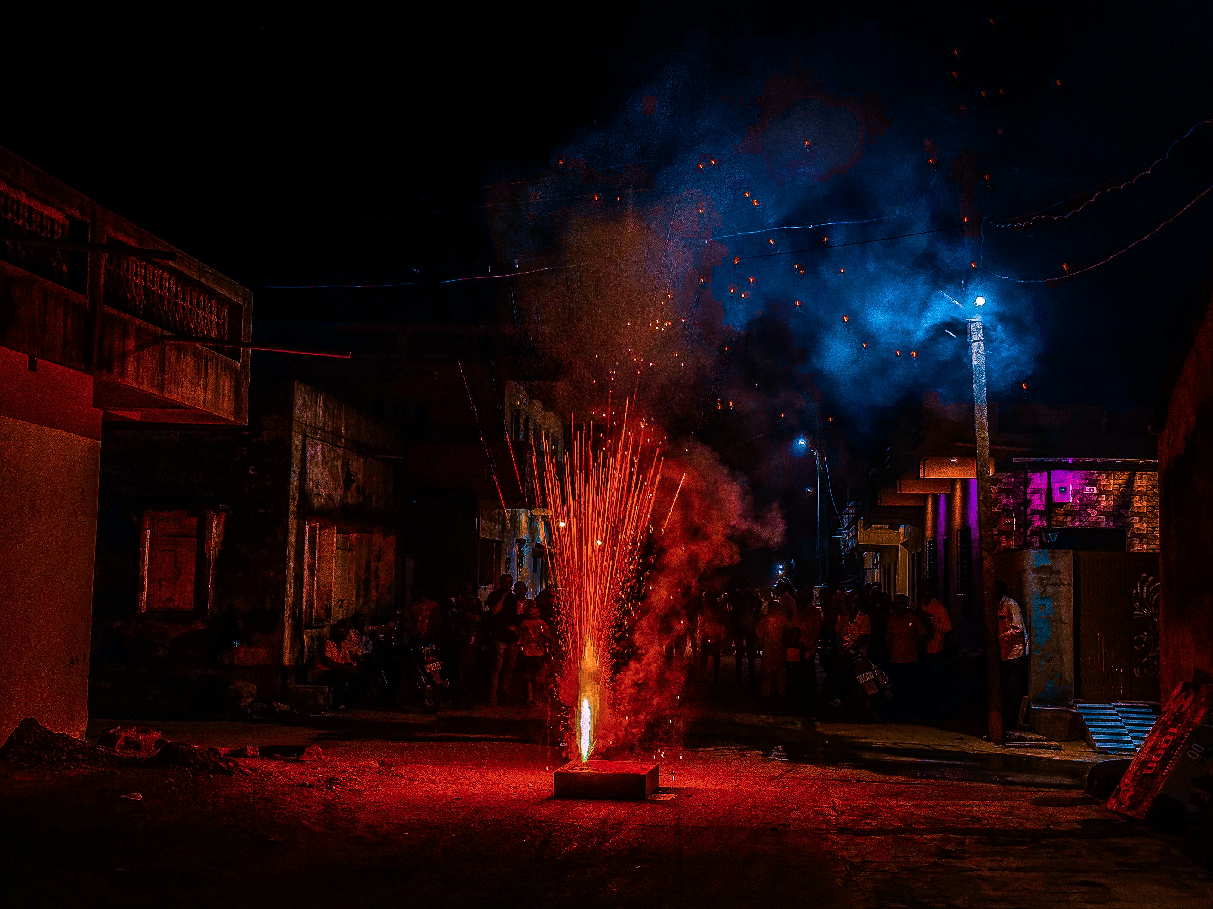 A group of people watching fireworks in the dark