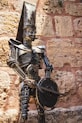 A statue of a man with a hat and a sword