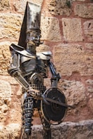 A statue of a man with a hat and a sword