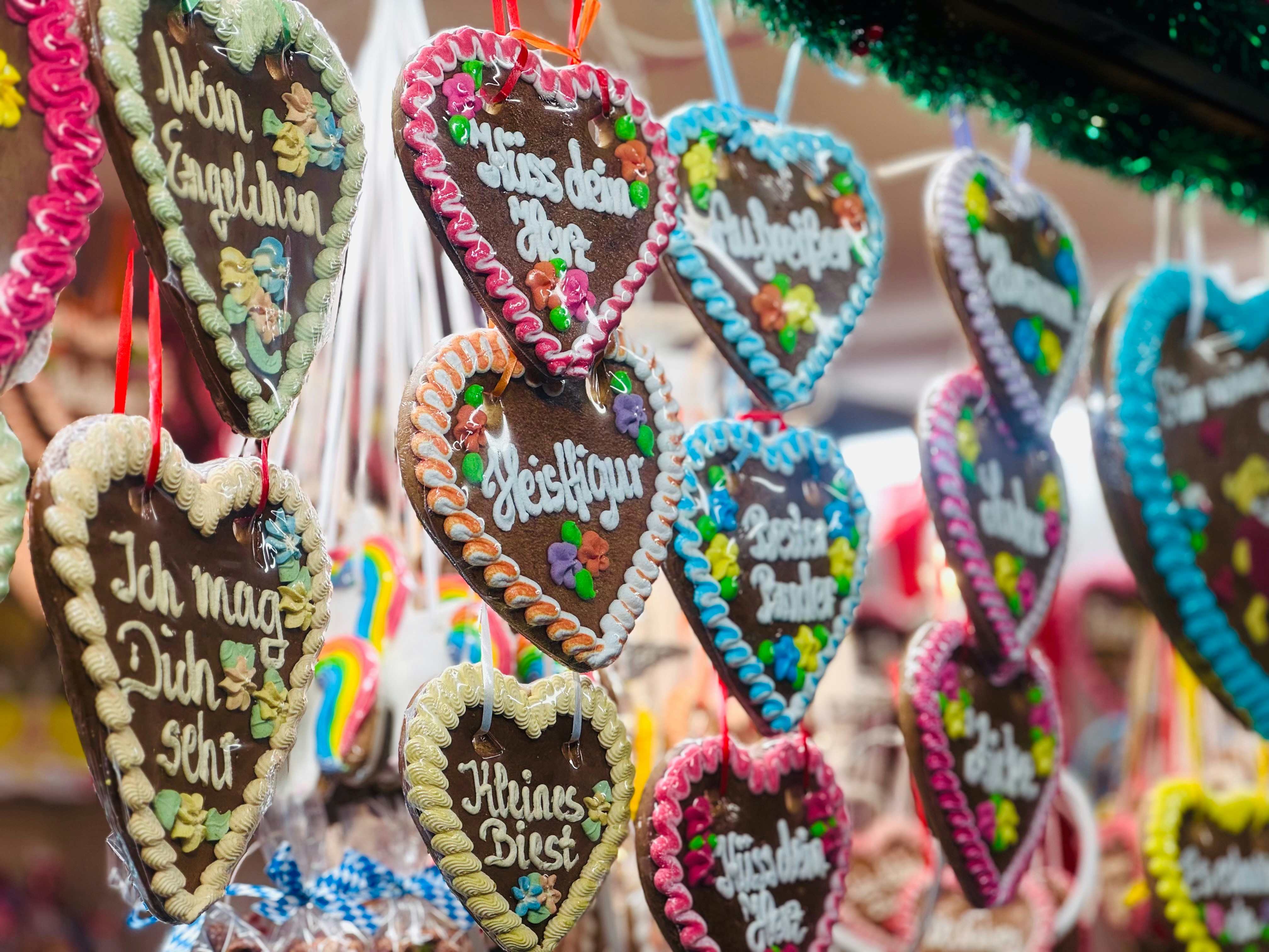 A bunch of heart shaped cookies hanging from strings