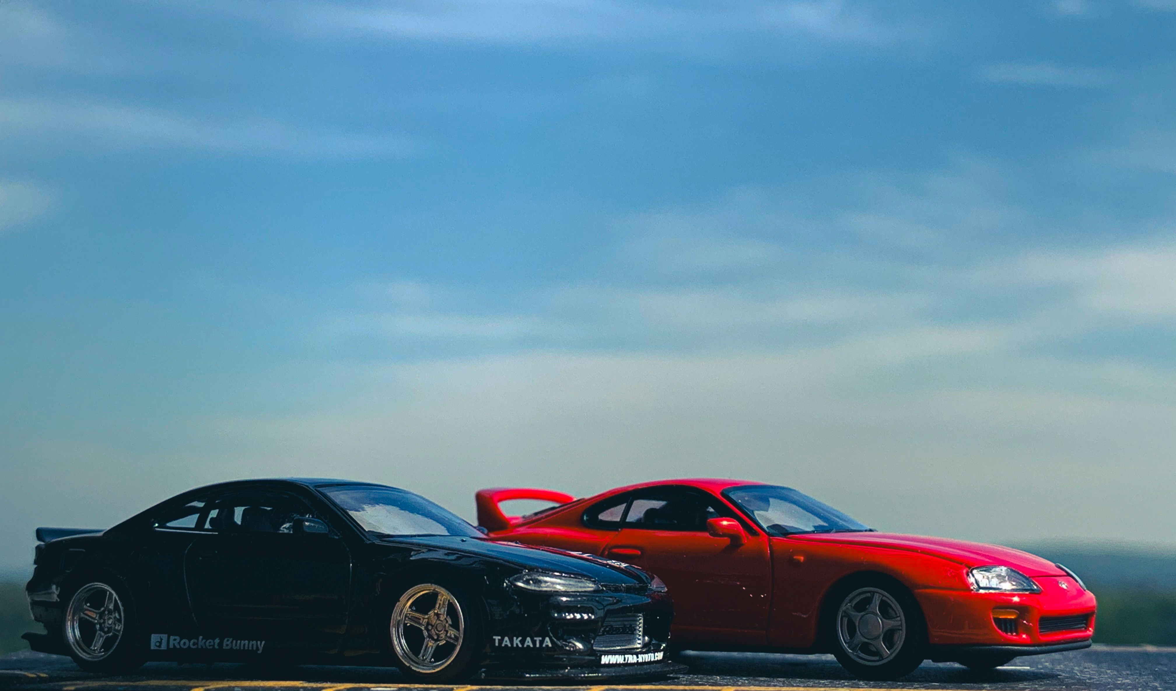 A couple of cars parked next to each other on a road