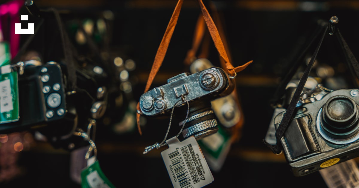 A group of cameras hanging on a wall photo – Free Electronics Image on ...