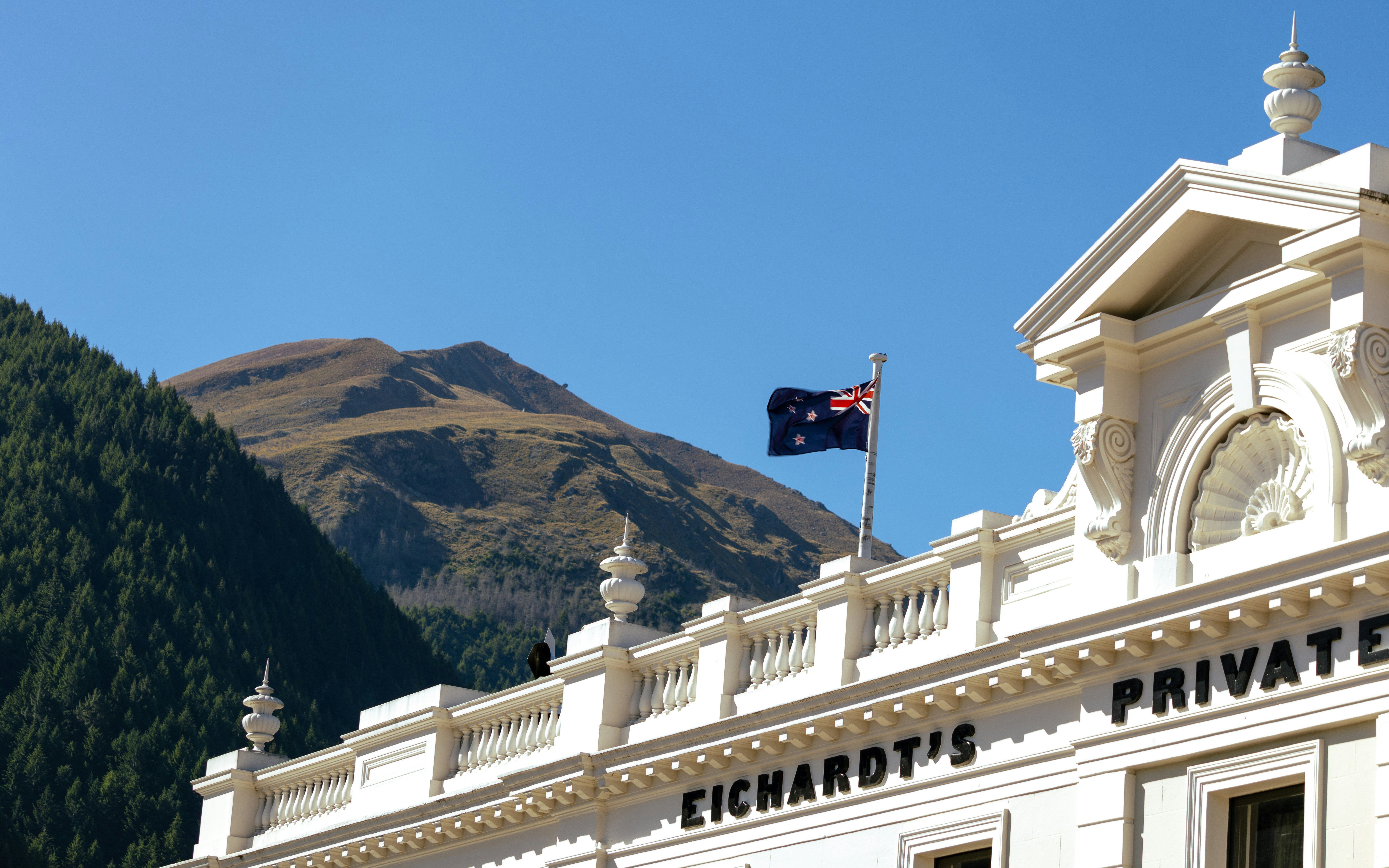 A large white building with a flag on top of it