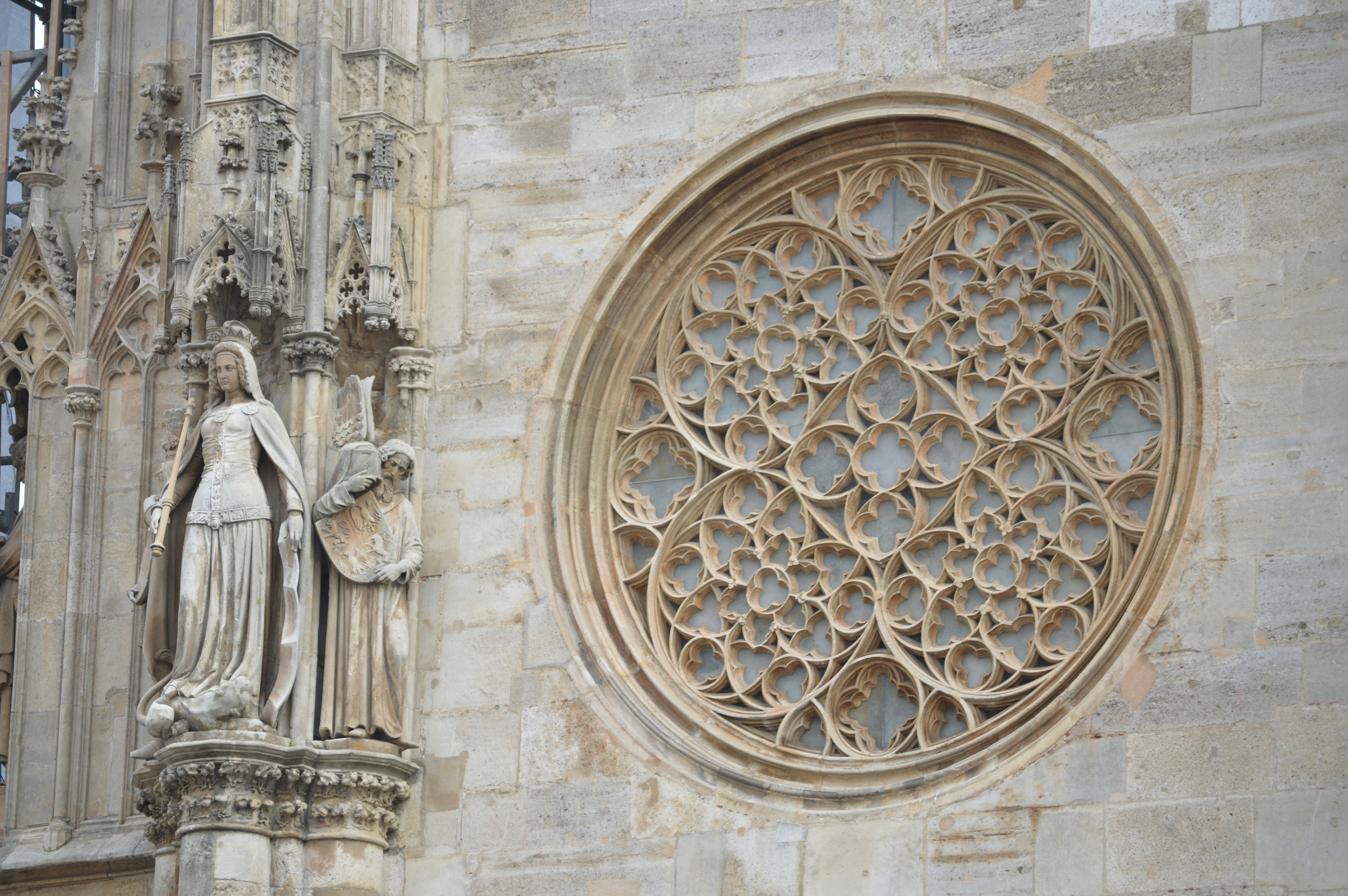 A statue of an angel next to a window, Vienna: A Symphony of History, Art, and Timeless Architecture