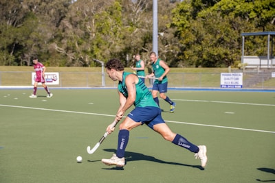 A group of people playing a game of field hockey