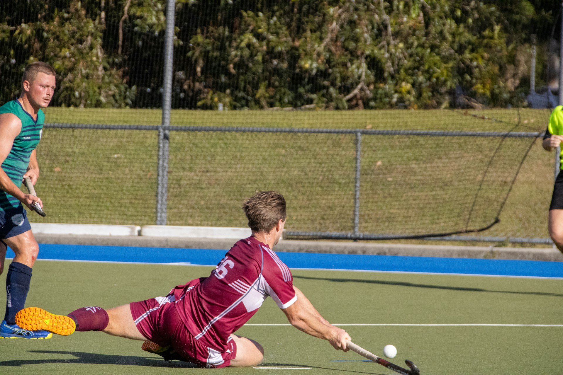 A group of men playing a game of field hockey